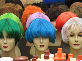 A colorful display of wigs and hair care products at the Albert Cuyp market.