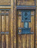 Weathered wood and handcrafted iron work make for an interesting door.