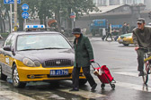 She makes an easy crossing before Beijing rush hour traffic begins.