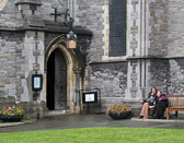 Two tired tourists take a break outside Dublin's Christ Church Cathedral.