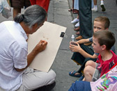 The sidewalk artist is one of many who depend on the tourists to earn their living.