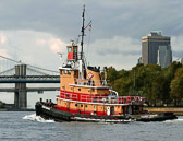 The tug is heading downtown towards the lower tip of Manhattan.