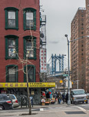 The Manhattan Bridge to Brooklyn viewed from a Chinatown street corner.