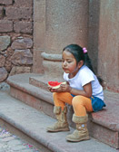 She's deep in thought while eating watermelon in the village of Yucay.